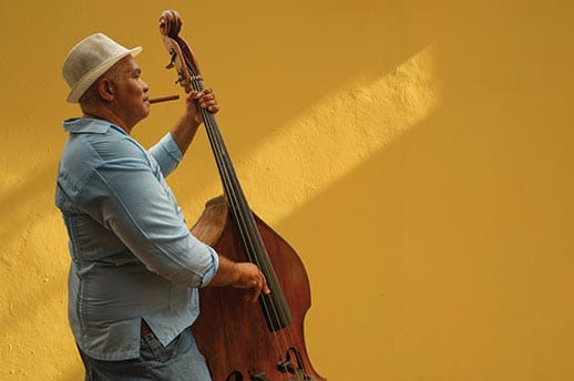 A man placing a double bass